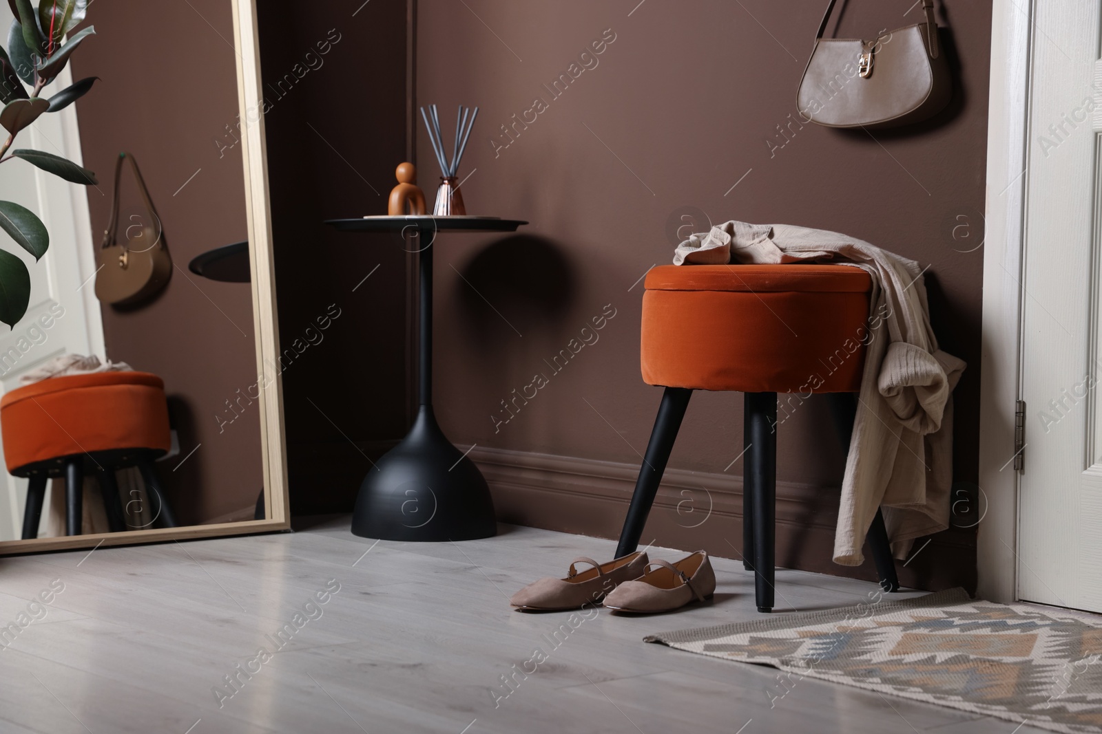 Stylish pouf with shirt and shoes at home Photo of Stylish pouf with shirt and shoes at home
