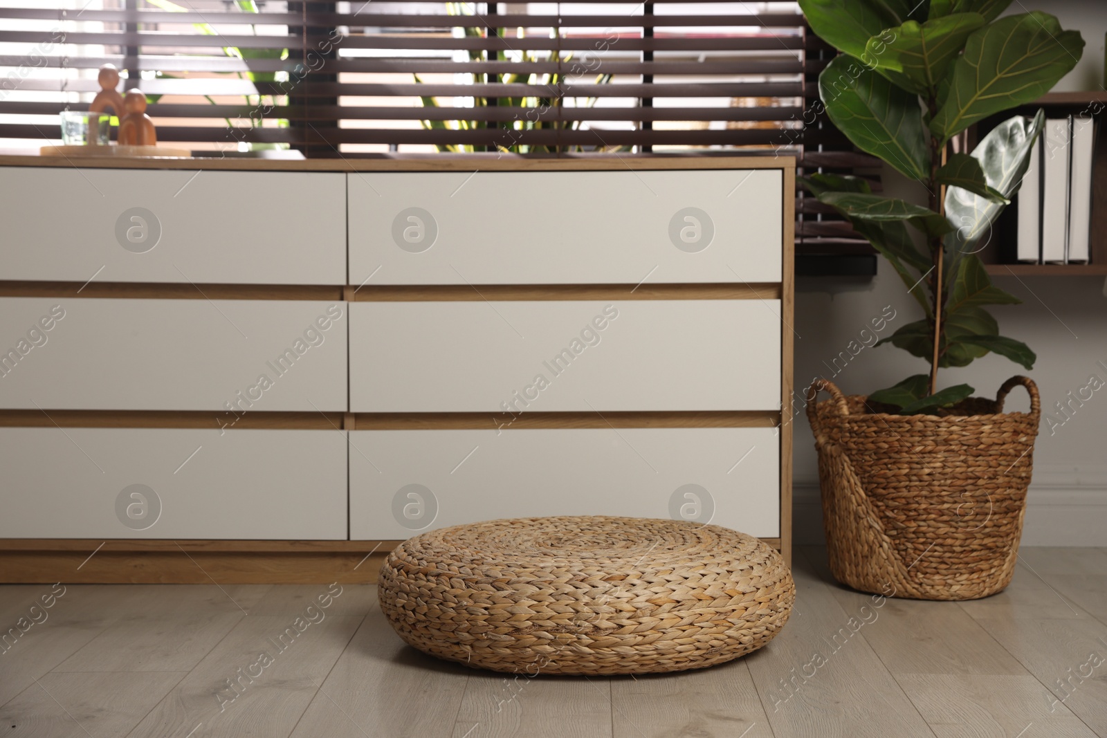 Photo of Stylish wicker pouf and home decor indoors
