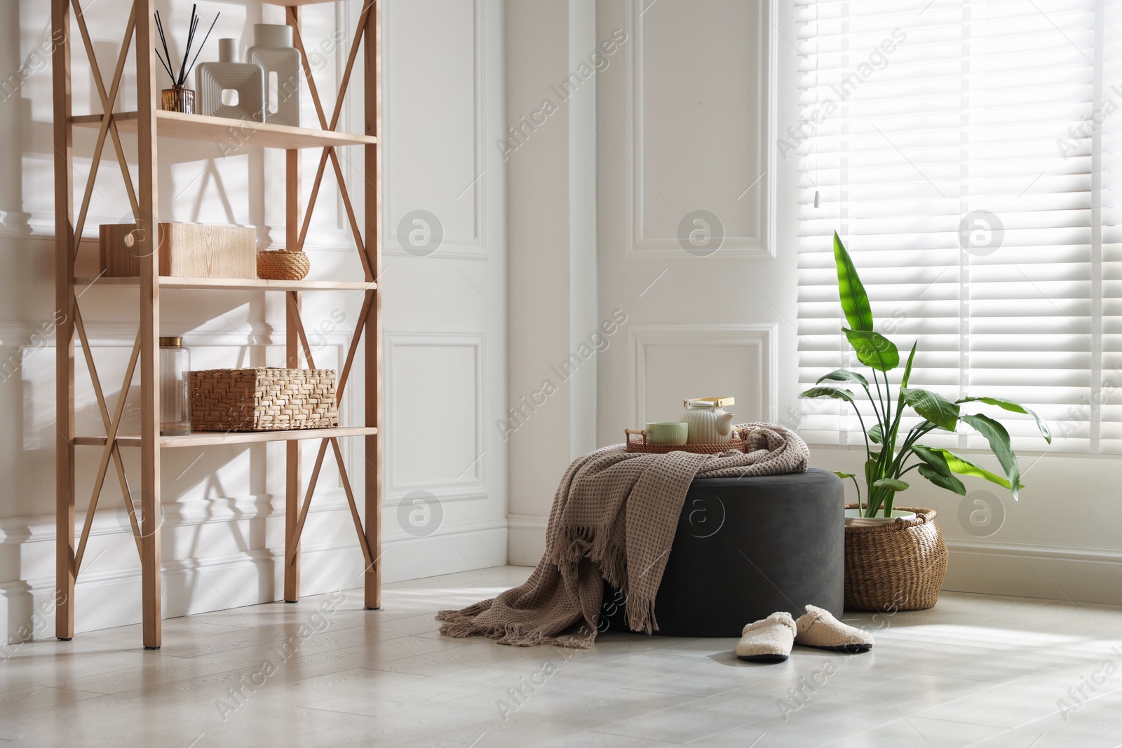 Stylish pouf with tea set at home Photo of Stylish pouf with tea set at home