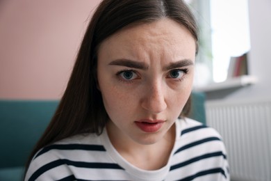 Photo of Scared woman suffering from paranoia at home