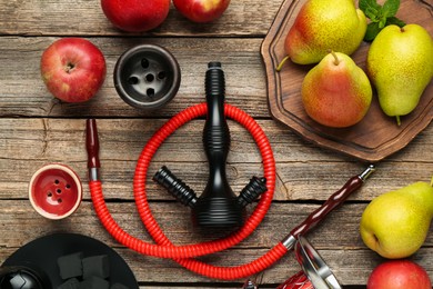 Photo of Hookah, coal and fresh fruits on wooden table, flat lay