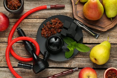 Photo of Hookah, coal and fresh fruits on wooden table, flat lay