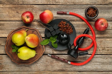 Photo of Hookah, coal and fresh fruits on wooden table, flat lay