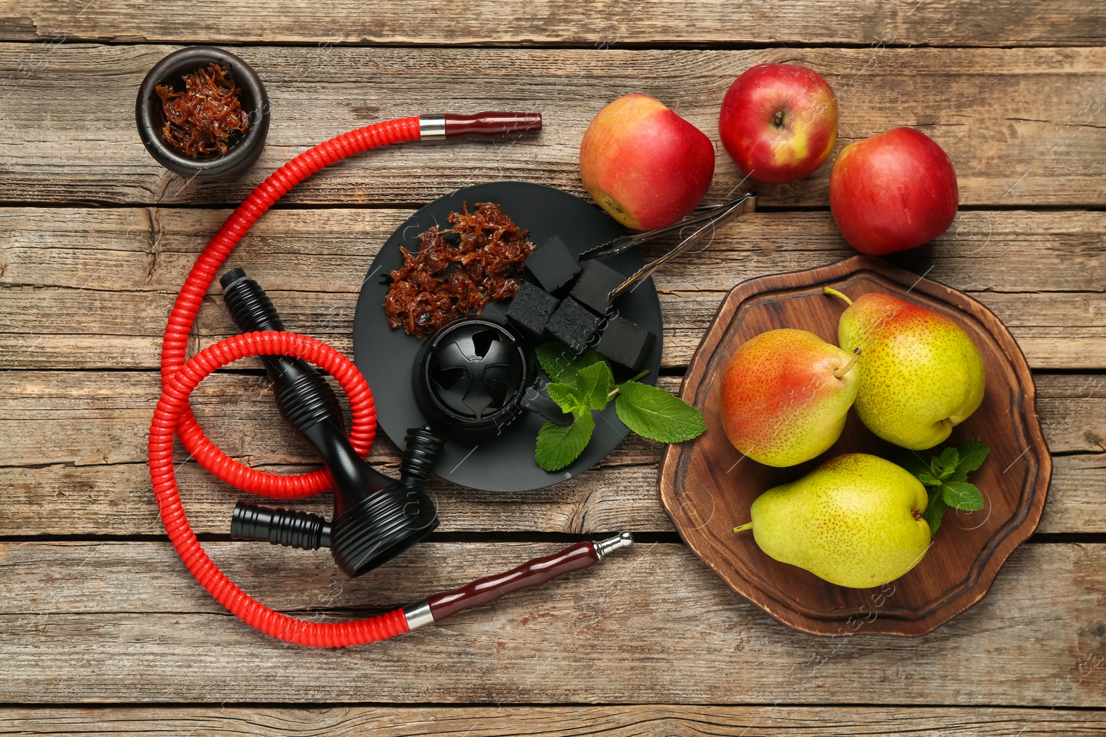 Photo of Hookah, coal and fresh fruits on wooden table, flat lay