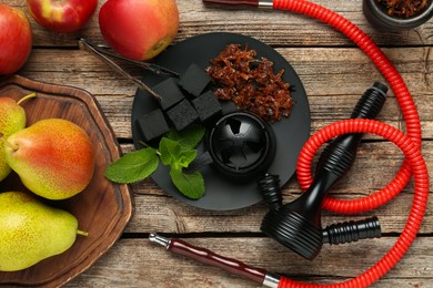 Photo of Hookah, coal and fresh fruits on wooden table, flat lay