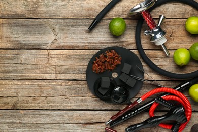 Photo of Hookah, coal and fresh fruits on wooden table, flat lay. Space for text