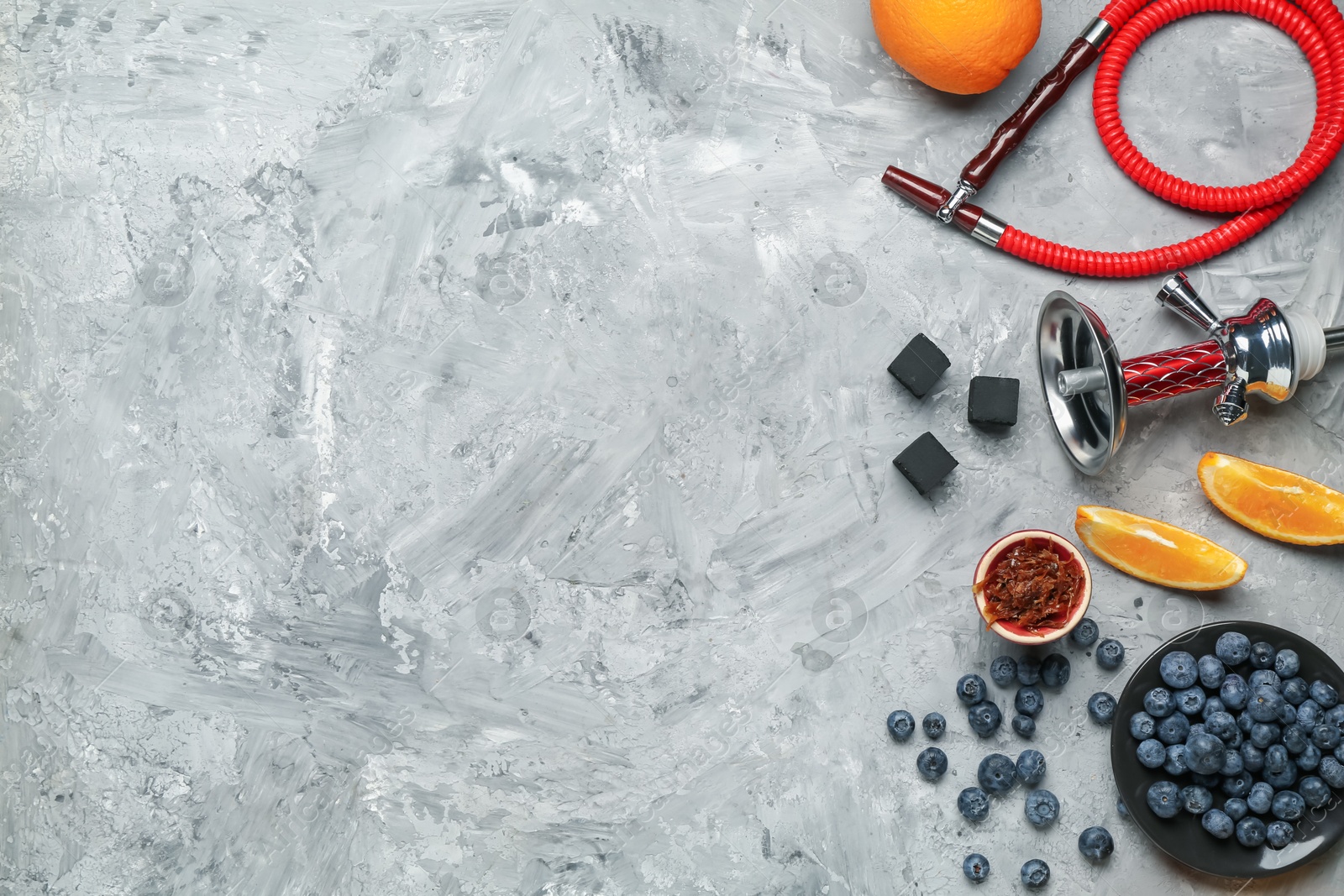 Photo of Hookah, coal and fresh fruits on grey table, flat lay. Space for text