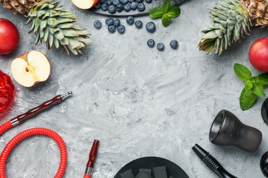 Photo of Frame of hookah and fresh fruits on grey table, flat lay. Space for text