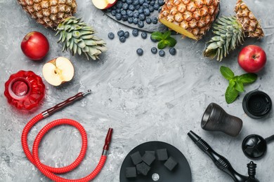 Photo of Frame of hookah and fresh fruits on grey table, flat lay. Space for text