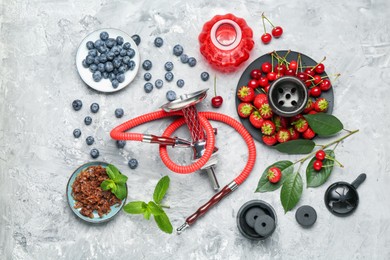 Photo of Hookah and fresh fruits on grey table, flat lay