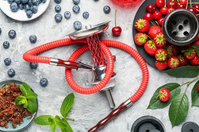 Photo of Hookah and fresh fruits on grey table, flat lay