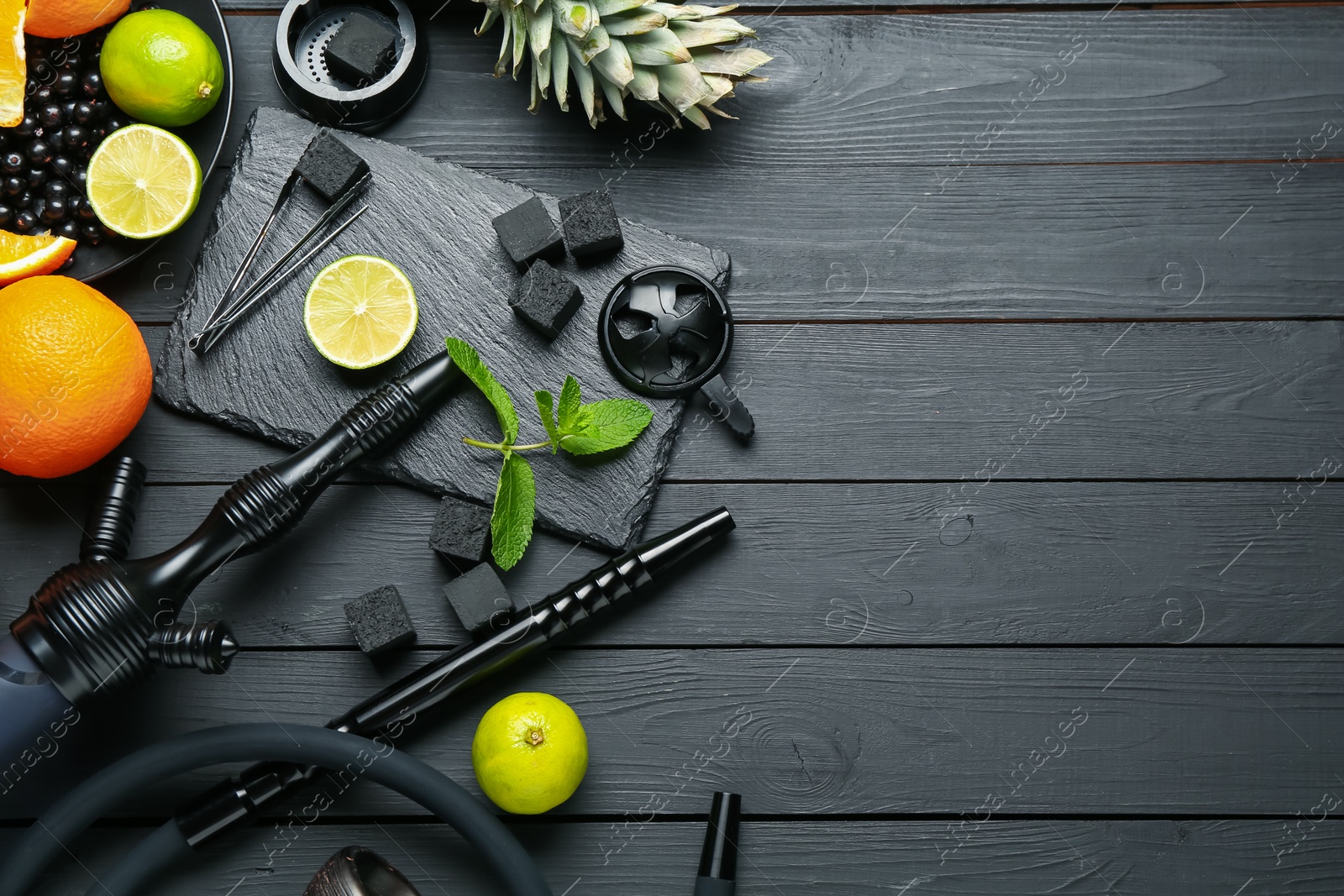 Hookah, coal and fresh fruits on black wooden table, flat lay. Space for text Photo of Hookah, coal and fresh fruits on black wooden table, flat lay. Space for text