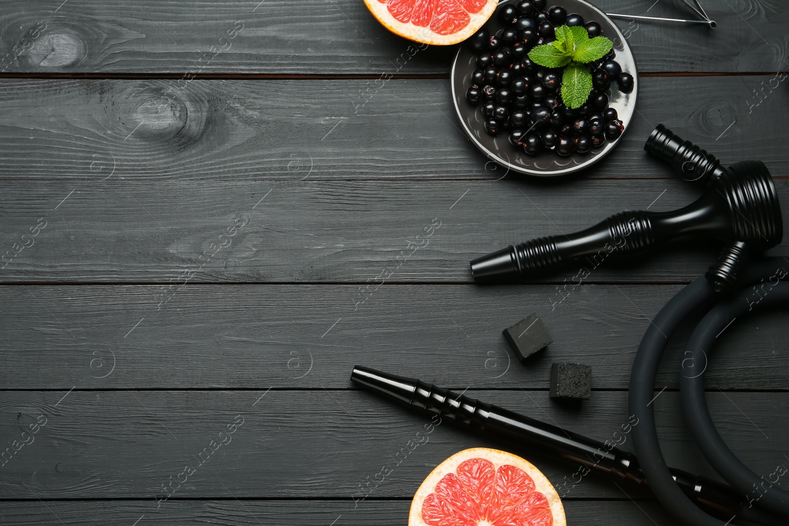 Hookah, coal and fresh fruits on black wooden table, flat lay. Space for text Photo of Hookah, coal and fresh fruits on black wooden table, flat lay. Space for text