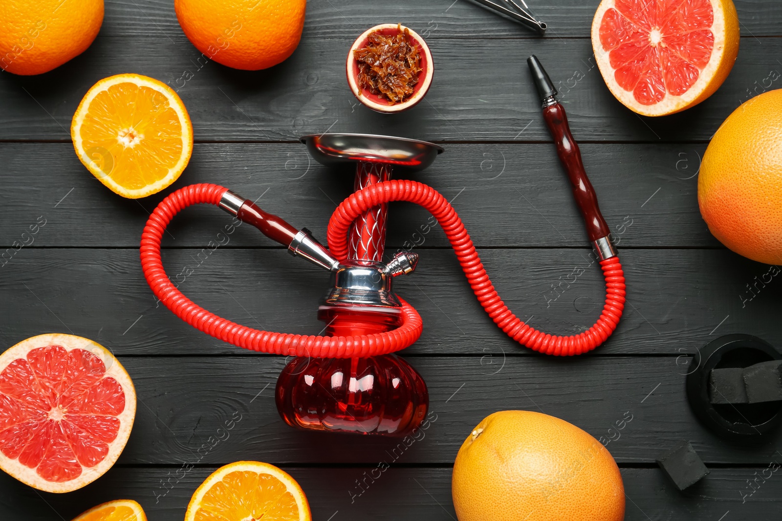 Hookah, coal and fresh fruits on black wooden table, flat lay Photo of Hookah, coal and fresh fruits on black wooden table, flat lay