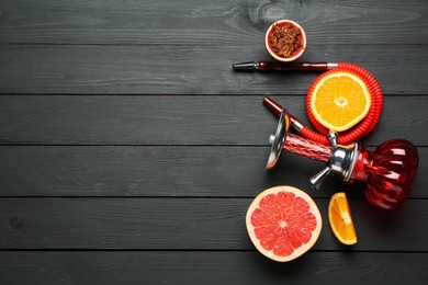 Photo of Hookah and fresh fruits on black wooden table, flat lay. Space for text