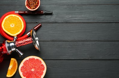 Photo of Hookah and fresh fruits on black wooden table, flat lay. Space for text