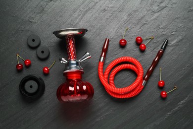 Photo of Hookah and cherries on black table, flat lay