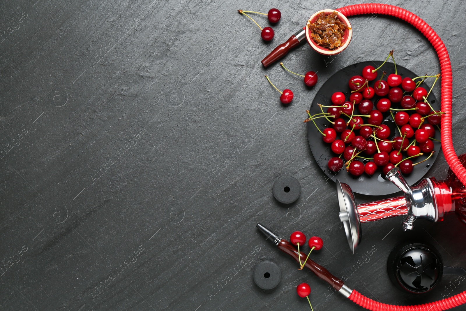 Photo of Hookah and cherries on black table, flat lay. Space for text