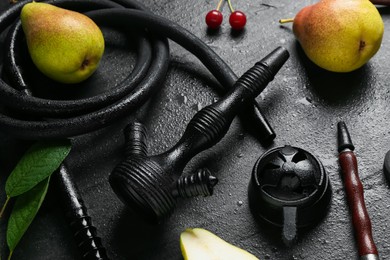 Photo of Hookah and fresh fruits on black table, closeup
