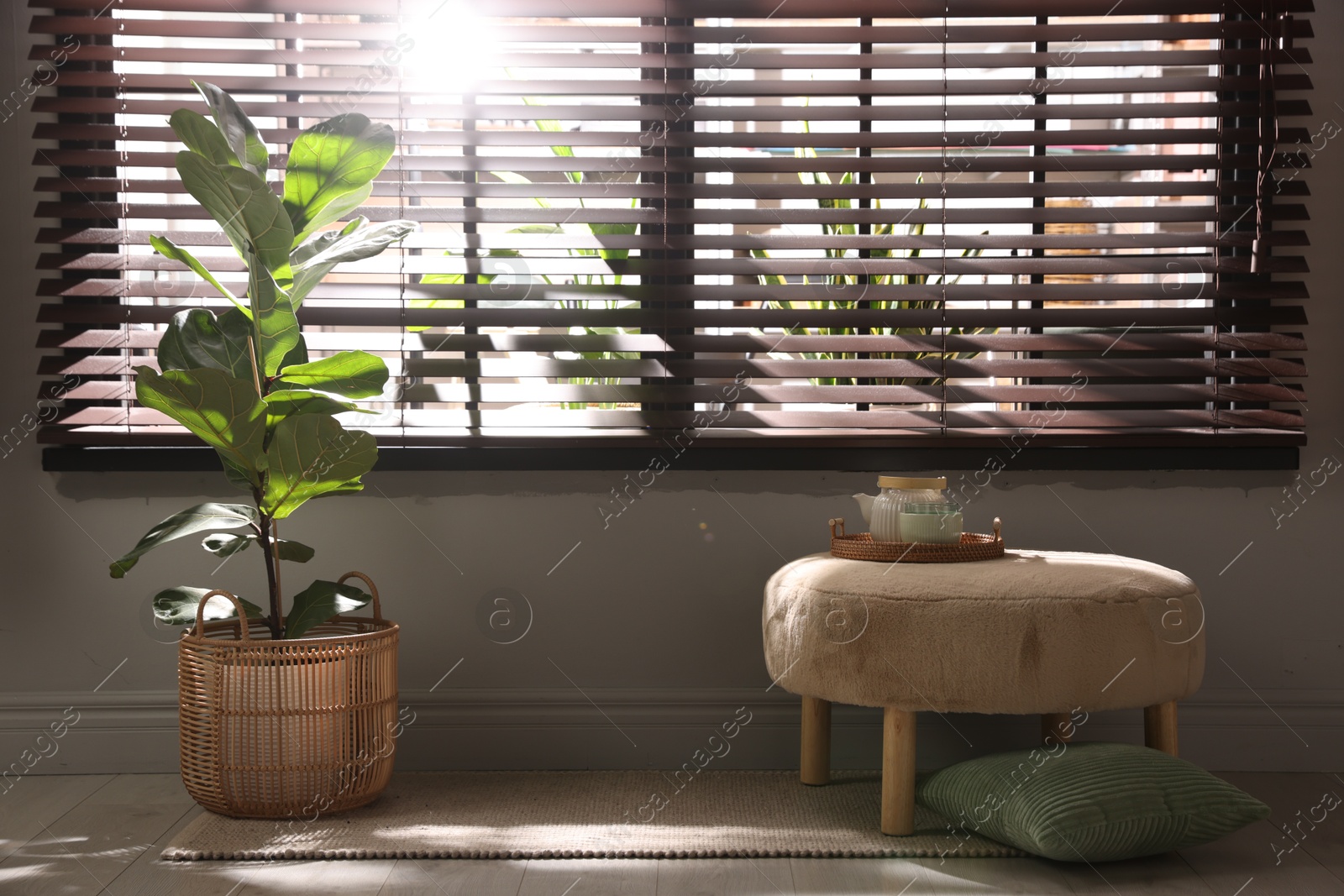 Stylish pouf with tea set at home Photo of Stylish pouf with tea set at home