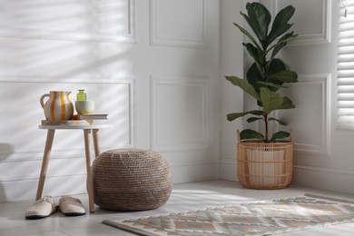 Photo of Stylish knitted pouf and home decor indoors