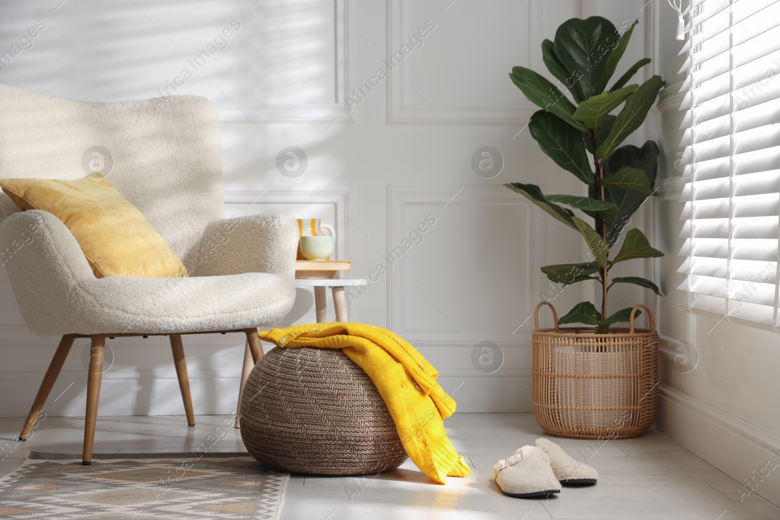 Photo of Stylish knitted pouf with sweater at home