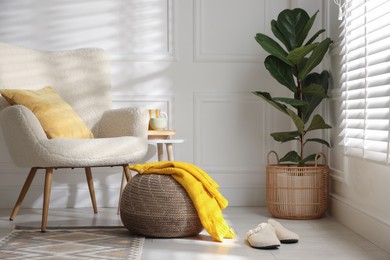 Photo of Stylish knitted pouf with sweater at home