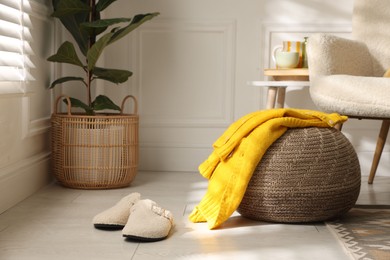 Photo of Stylish knitted pouf with sweater at home