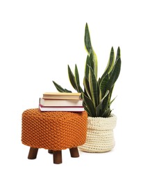 Photo of Stylish pouf with books and home decor isolated on white