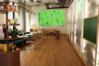Image of Broadcasting soccer match on TV set in bar