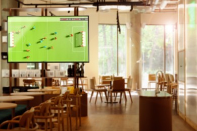 Image of Broadcasting soccer match on TV set in bar