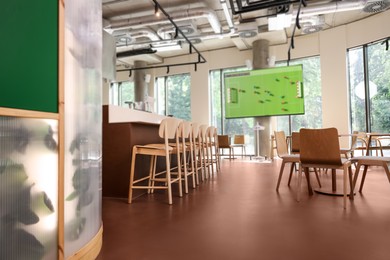 Image of Broadcasting soccer match on TV set in bar, low angle view