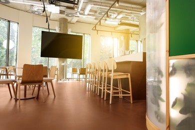 Image of TV set for event broadcasting in bar, low angle view