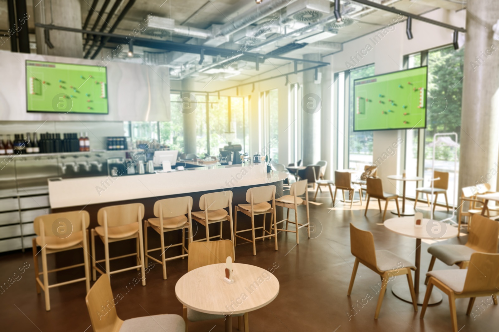 Broadcasting soccer match on TV sets in bar Image of Broadcasting soccer match on TV sets in bar