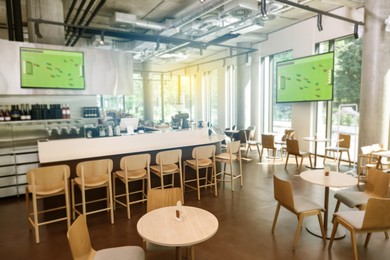 Image of Broadcasting soccer match on TV sets in bar