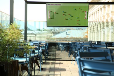Image of Broadcasting soccer match on TV set in bar