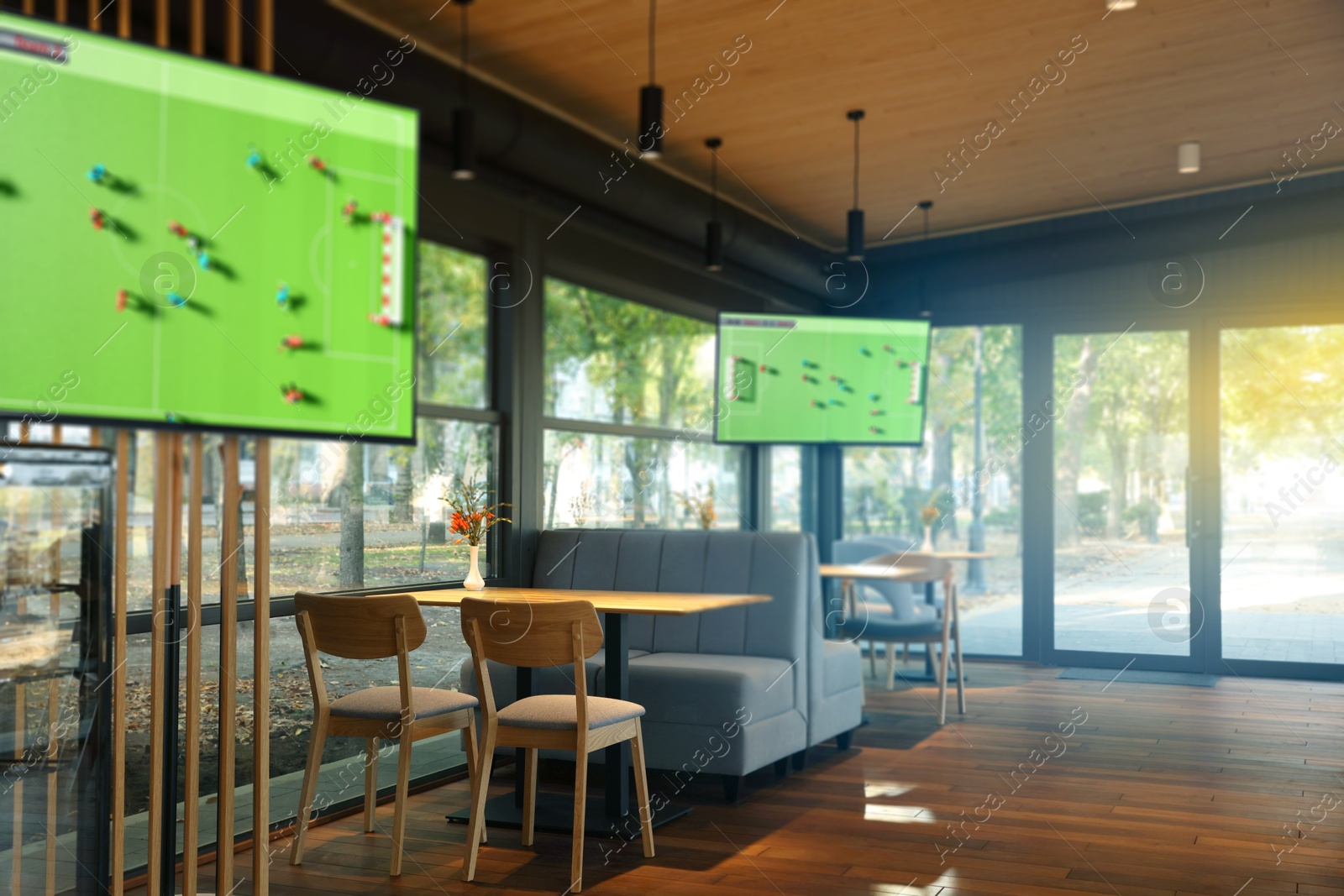Image of Broadcasting soccer match on TV sets in bar