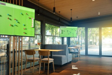 Image of Broadcasting soccer match on TV sets in bar