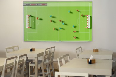 Image of Broadcasting soccer match on TV set in bar