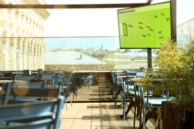 Image of Broadcasting soccer match on TV set in bar
