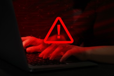 Image of Cyber attack alert notification. Red warning sign, circuit board and photo of hacker using laptop