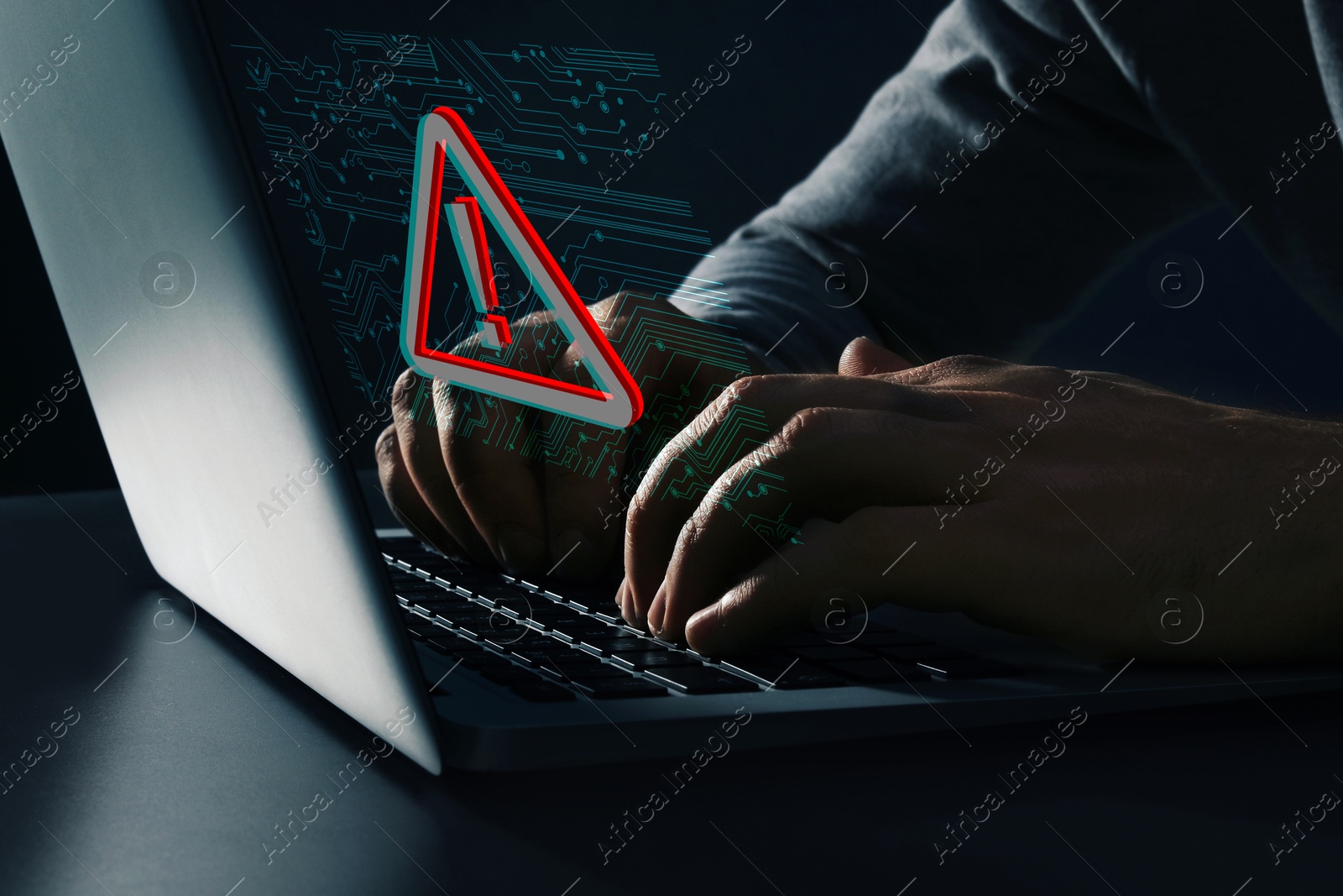 Image of Cyber attack alert notification. Red warning sign and circuit board on virtual screen. Hacker using laptop, closeup