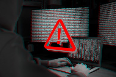 Image of Cyber attack alert notification. Red warning sign on virtual screen. Hacker using laptop, closeup