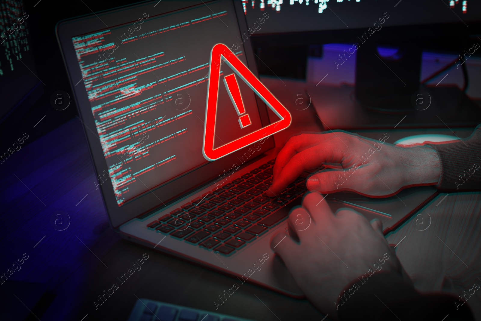 Image of Cyber attack alert notification. Red warning sign on virtual screen. Hacker using laptop, closeup