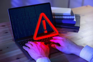 Image of Cyber attack alert notification. Red warning sign on virtual screen. Man using laptop, closeup