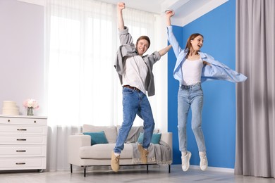 Photo of Happy couple dancing at home, low angle view