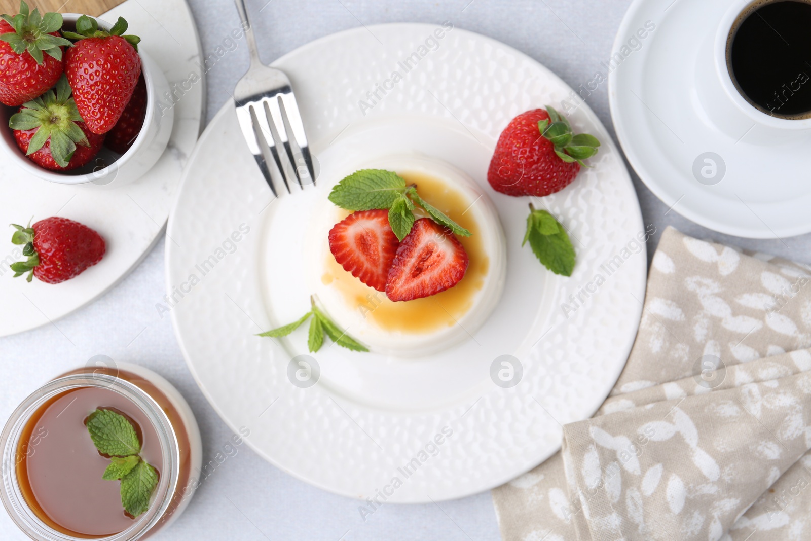 Tasty panna cotta served on light table, flat lay Photo of Tasty panna cotta served on light table, flat lay