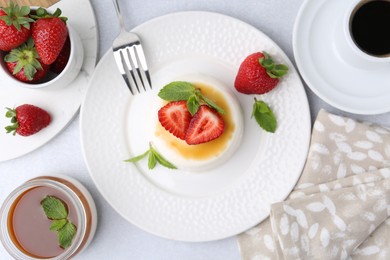 Photo of Tasty panna cotta served on light table, flat lay