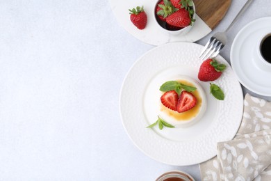 Photo of Tasty panna cotta with caramel, strawberries, mint and coffee on light table, flat lay. Space for text