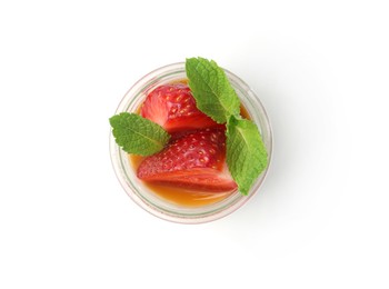 Photo of Tasty panna cotta with caramel, strawberries and mint in glass jar isolated on white, top view